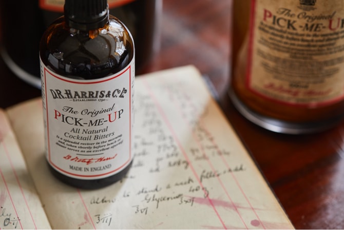The Original Pick-Me-Up bottle placed on vintage handwritten recipe book